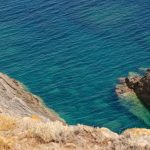 Rocky cliffside meets turquoise ocean waters.