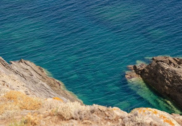 Rocky cliffside meets turquoise ocean waters.