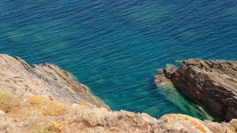 Rocky cliffside meets turquoise ocean waters.